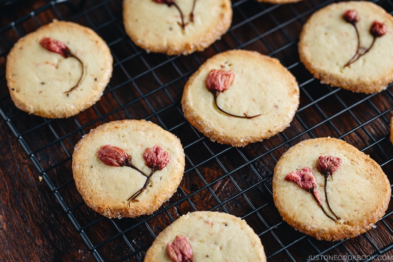 Cherry blossom cookies on a wire rack.