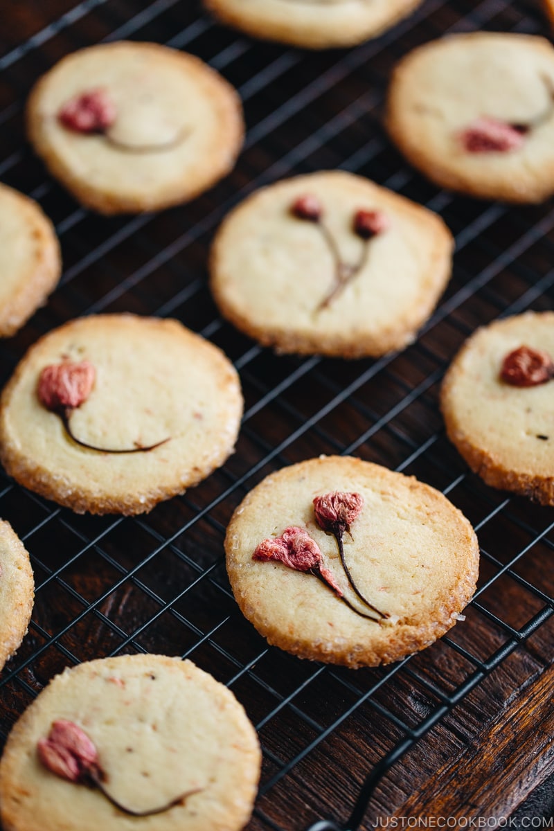 Cherry blossom cookies on a wire rack.