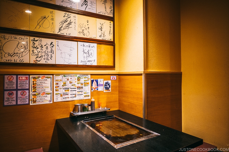 interior of Ajinoya okonomiyaki restaurant with hot plate table- Osaka Guide: Dotonbori and Namba | www.justonecookbook.com