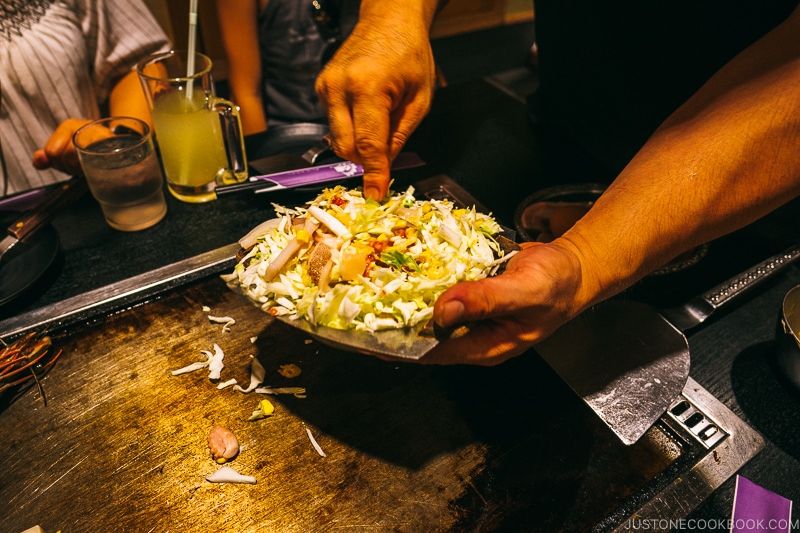 okonomiyaki mixture about to poured onto hot plate at Ajinoya - Osaka Guide: Dotonbori and Namba | www.justonecookbook.com