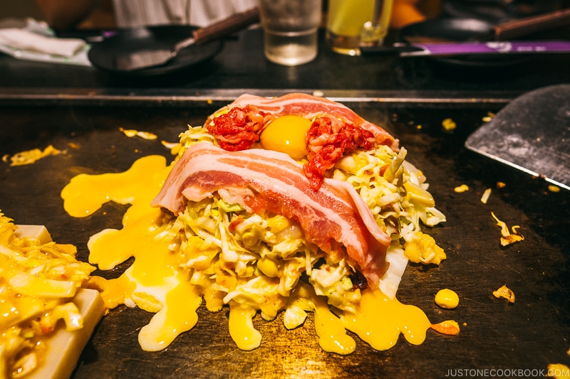 okonomiyaki being cook at Ajinoya - Osaka Guide: Dotonbori and Namba | www.justonecookbook.com