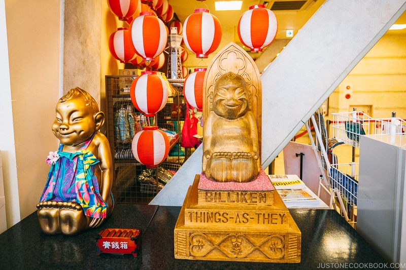 Billiken figures and statue at Tsutenkaku Tower - Osaka Guide: Tsutenkaku and Shinsekai District | www.justonecookbook.com