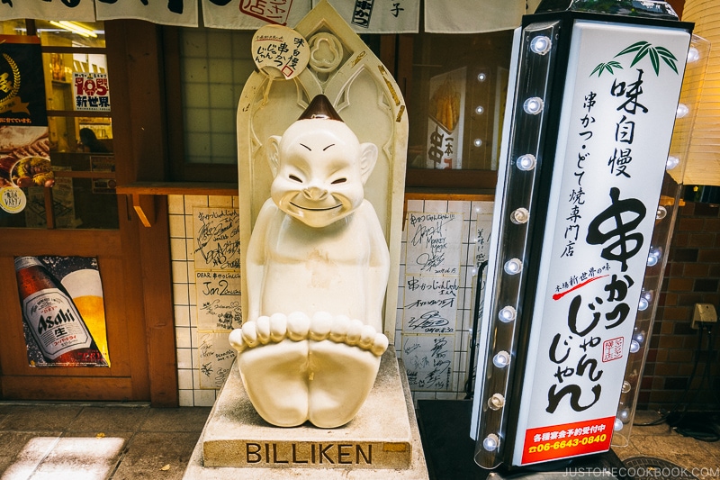 Billiken statue in front of a restaurant - Osaka Guide: Tsutenkaku and Shinsekai District | www.justonecookbook.com