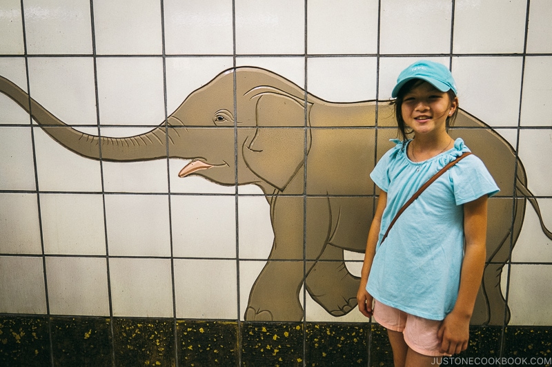 child standing in front of an elephant made of tiles - Osaka Guide: Tsutenkaku and Shinsekai District | www.justonecookbook.com