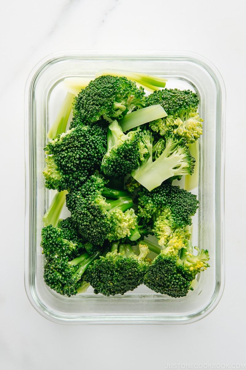 Blanched broccoli in the glass container.