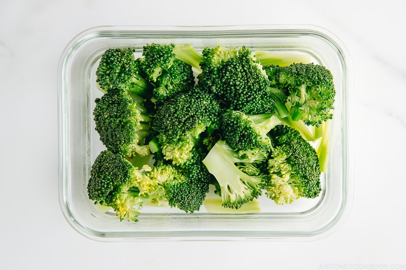 Blanched broccoli in the glass container.