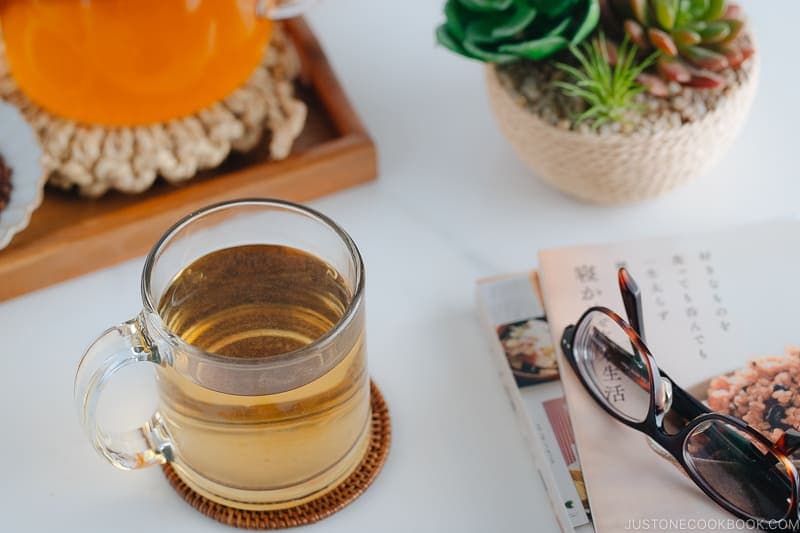 Hot buckwheat tea (sobacha) served in a glass cup.