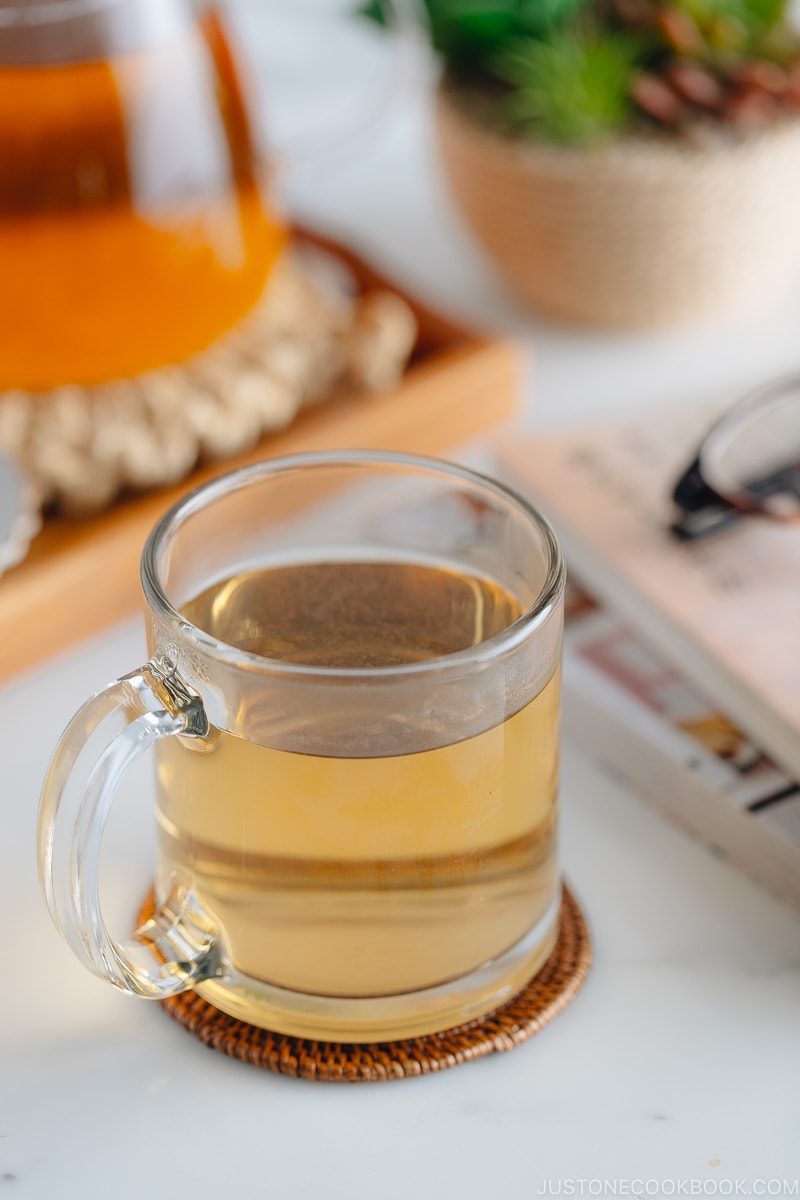 Hot buckwheat tea (sobacha) served in a glass cup.