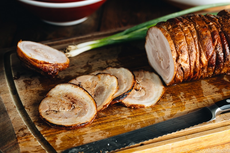 Thin slices of Chashu on the cutting board.