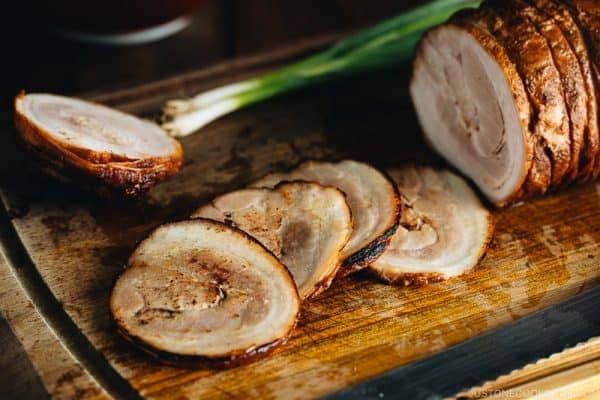 Thin slices of Chashu on the cutting board.