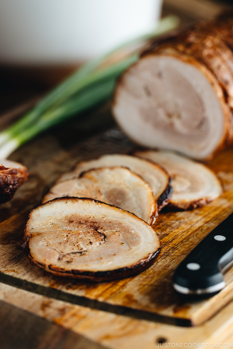 Thin slices of Chashu on the cutting board.