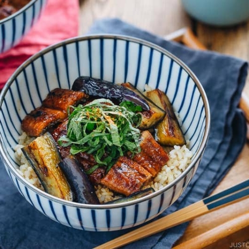 Eggplant & Unagi Over Rice in a Japanese blue and white bowl.