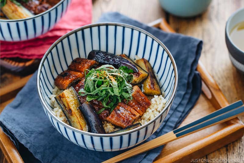 Eggplant & Unagi Over Rice in a Japanese blue and white bowl.