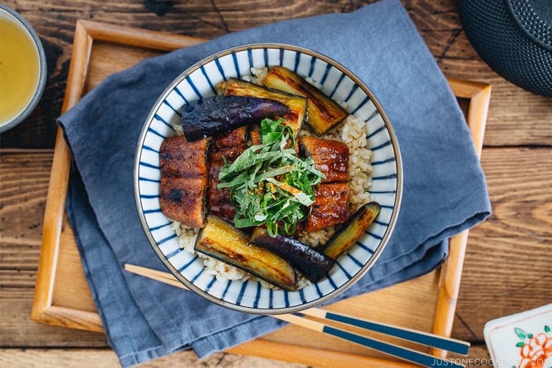 Eggplant & Unagi Over Rice in a Japanese blue and white bowl.