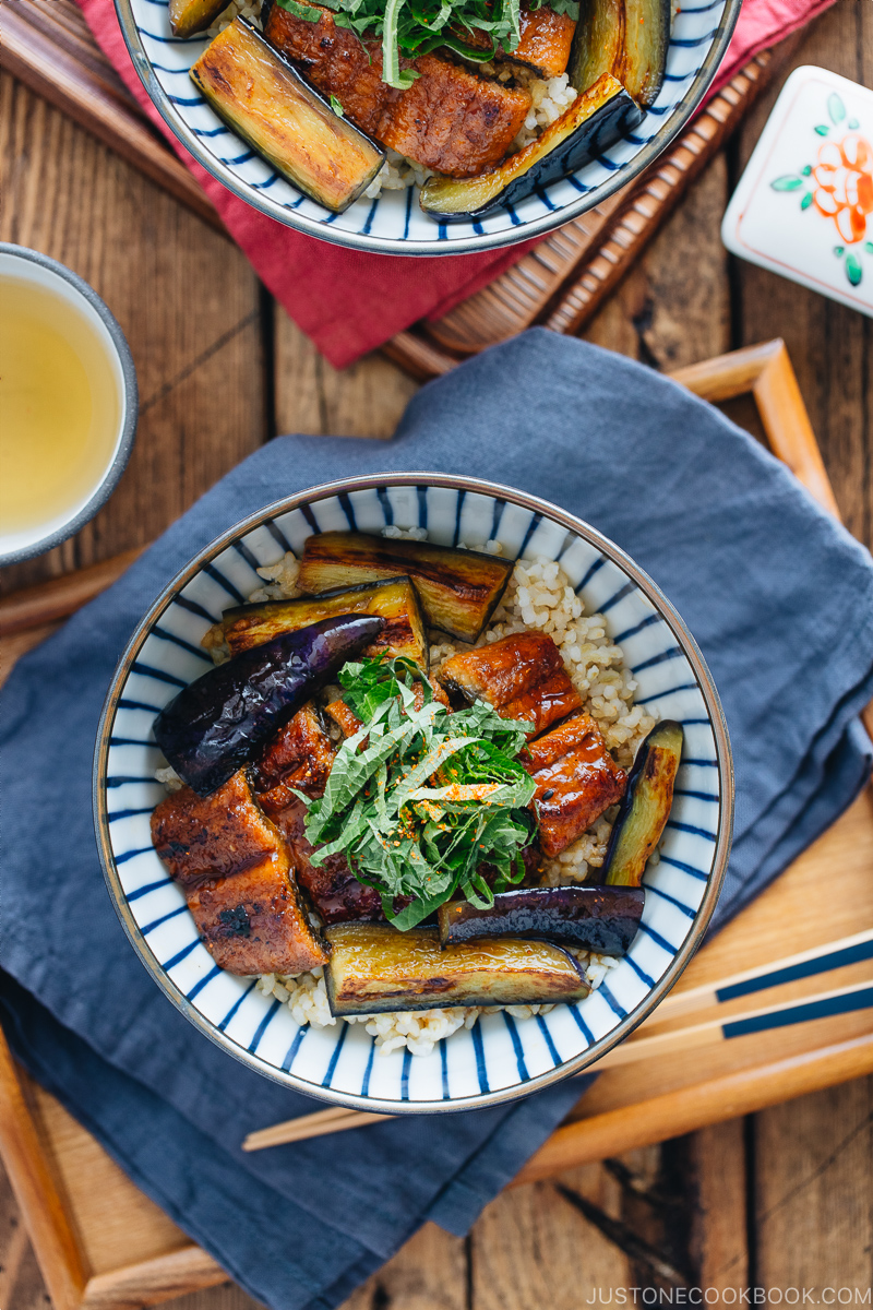 Eggplant & Unagi Over Rice in a Japanese blue and white bowl.