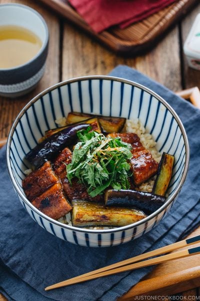 Eggplant & Unagi Over Rice in a Japanese blue and white bowl.