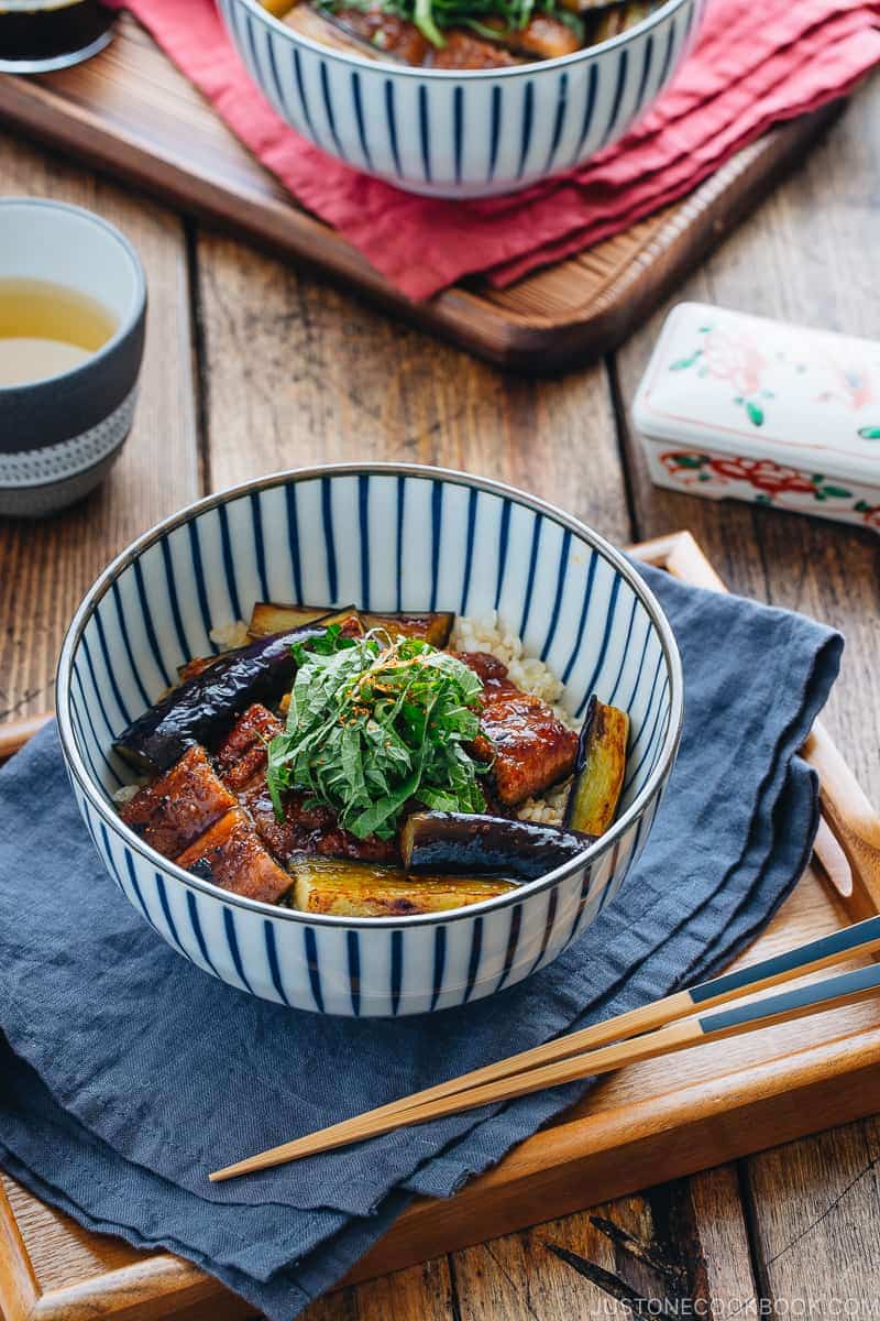 Eggplant & Unagi Over Rice in a Japanese blue and white bowl.