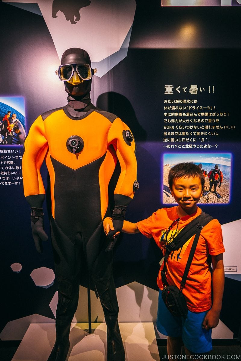 child standing next to diver's suit in Kaiyukan - Osaka Guide: Tempozan Harbor Village | www.justonecookbook.com