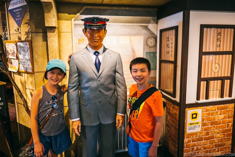 statue of station chief next to ticket booth at Naniwa Kushinbo Yokocho - Osaka Guide: Tempozan Harbor Village | www.justonecookbook.com