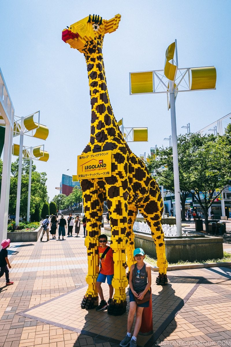 children standing next to a giant Lego giraffe view of downtown Osaka and Tempozan bridge from the giant Ferris wheel - Osaka Guide: Tempozan Harbor Village | www.justonecookbook.com