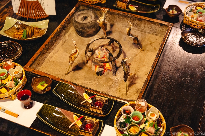 dinner served with a open pit in the middle of the table for grilling - Kaiseki Ryori: The Art of the Japanese Refined Multi-course Meal | www.justonecookbook.com