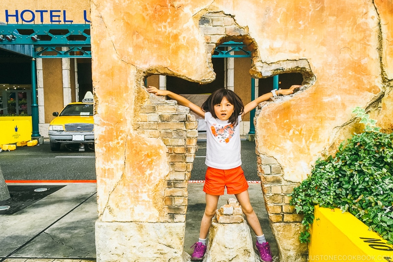 child posing inside a hole in a wall at Hotel Universal Port - Osaka Guide: Universal Studios Japan | www.justonecookbook.com