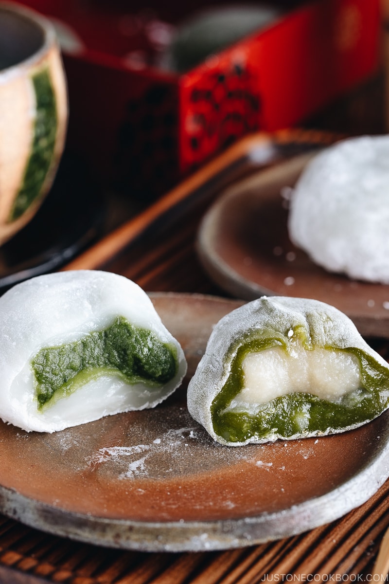 Green tea mochi showing green filling and white filling.