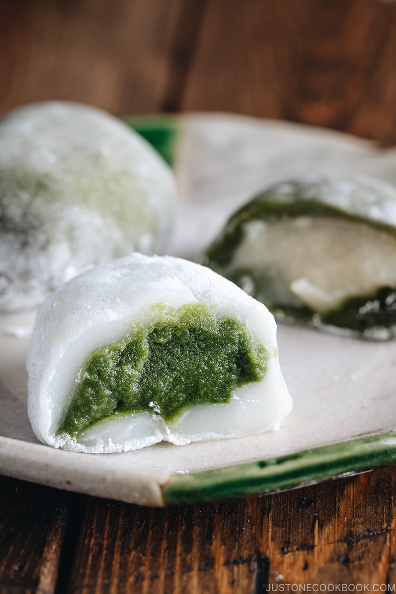 Green tea mochi showing green filling and white filling.