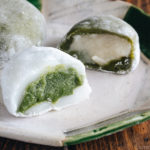 Green tea mochi showing green filling and white filling.