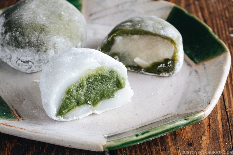 Green tea mochi showing green filling and white filling.