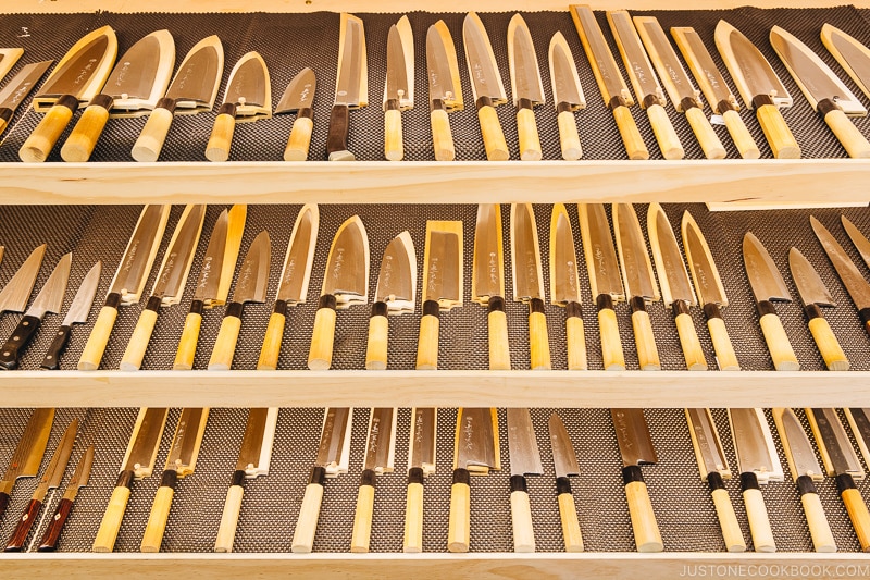 Japanese knives on a shelf.