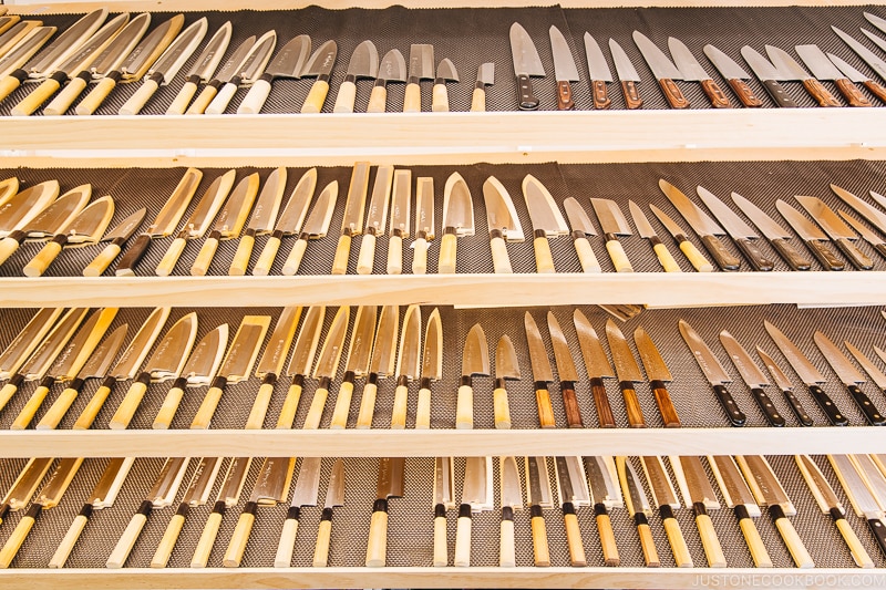 Japanese knives on a shelf.