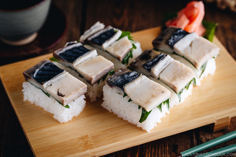 Mackerel Pressed Sushi (Saba Oshizushi) and sushi ginger are on the bamboo sushi tray.