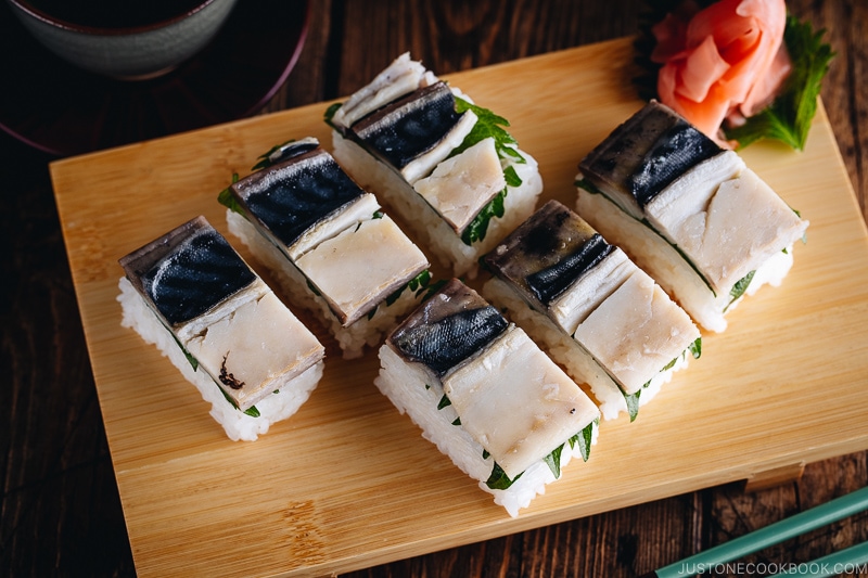 Mackerel Pressed Sushi (Saba Oshizushi) and sushi ginger are on the bamboo sushi tray.