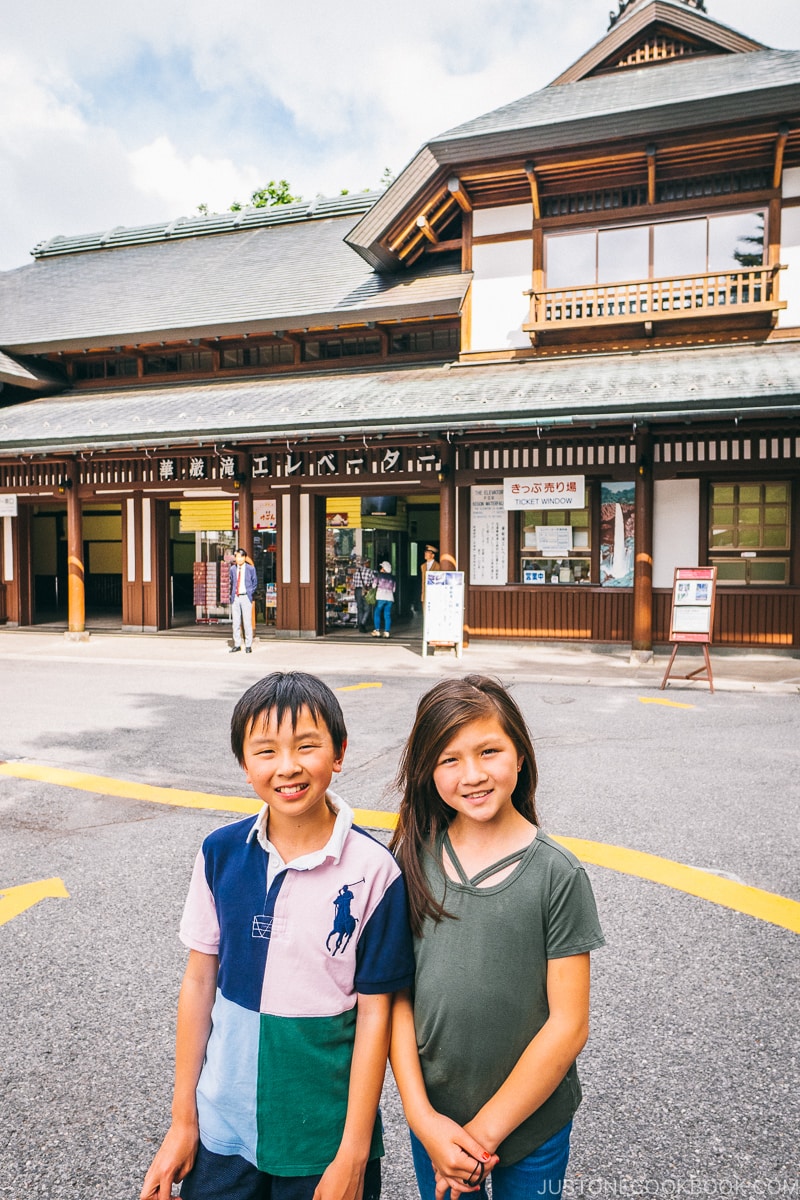 2 children in front of Kegon Falls elevator building - Kegon Falls and Akechidaira Plateau | www.justonecookbook.com