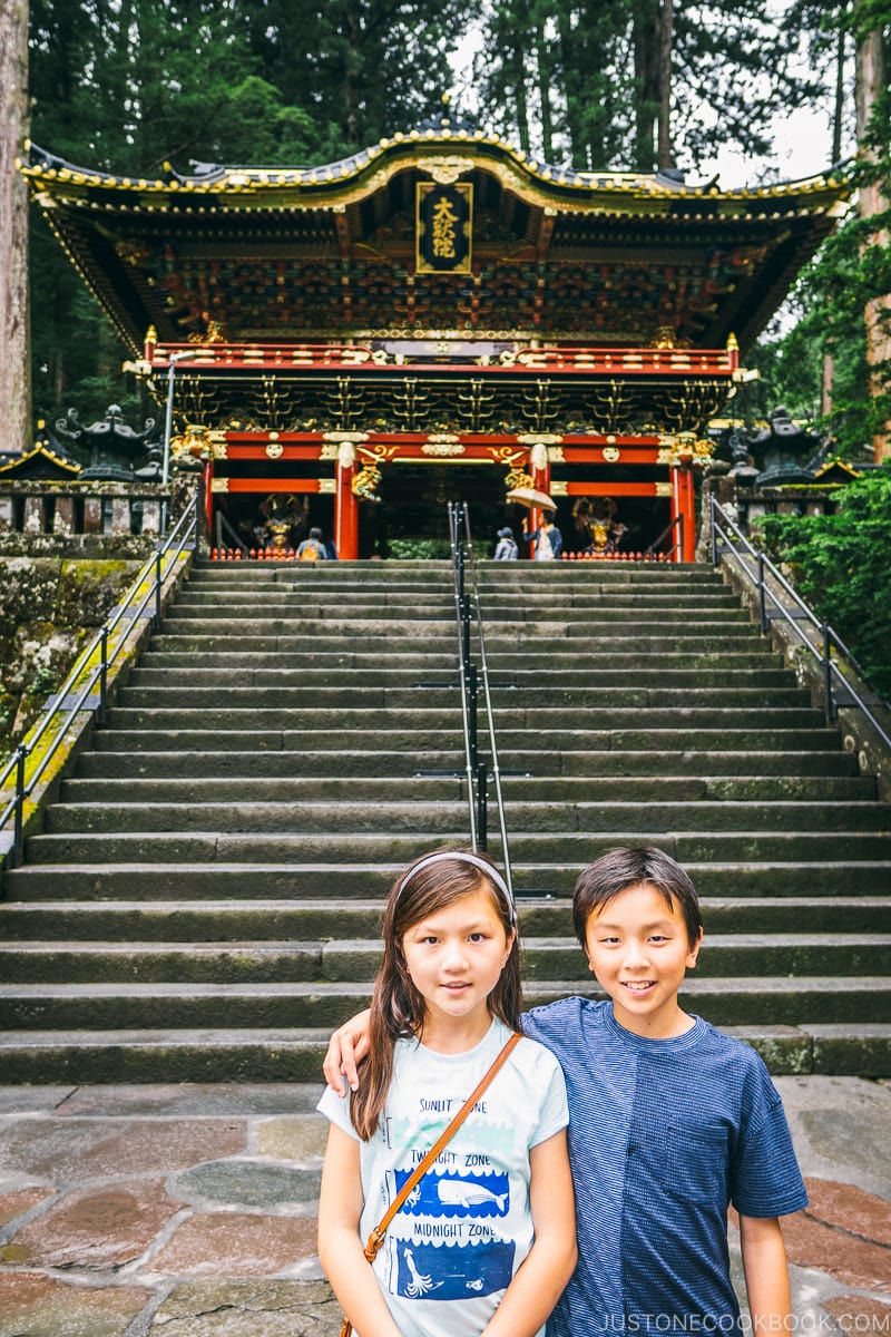 children standing in front of Nitenmon at Nikkosanrinnoji Taiyuin - Places to Visit and Things to do in Nikko | www.justonecookbook.com