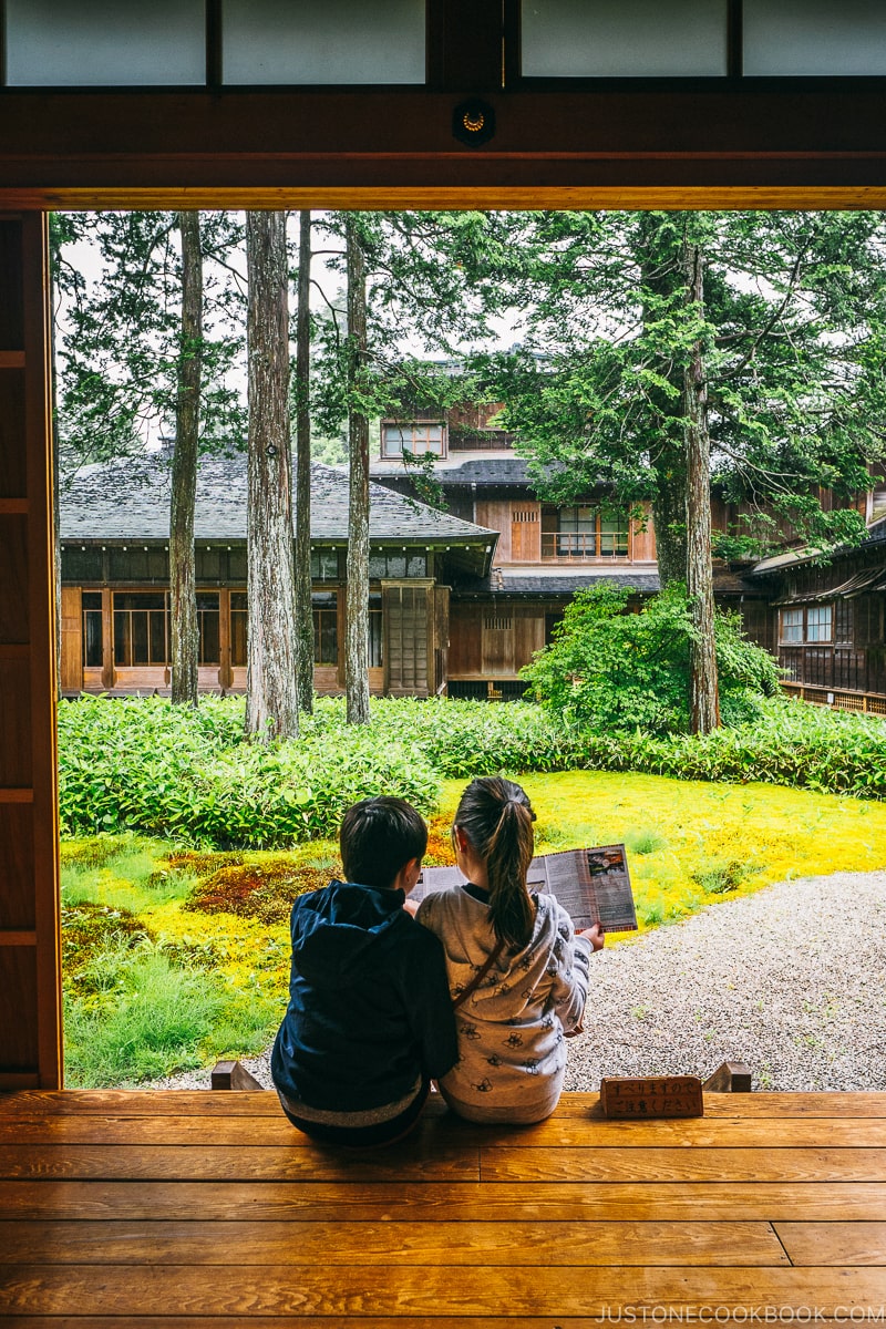 children looking into the garden of Nikko Tamozawa Imperial Villa Memorial Park - Places to Visit and Things to do in Nikko | www.justonecookbook.com