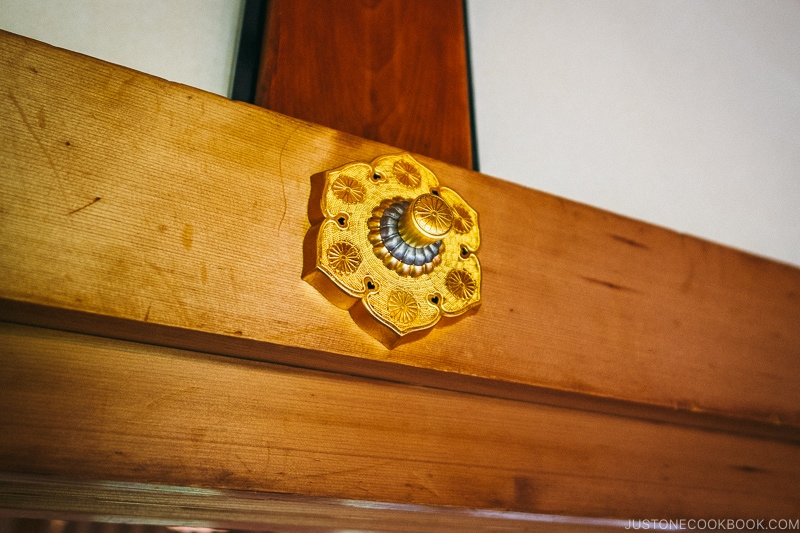 Imperial Family crest on wood beam at Nikko Tamozawa Imperial Villa Memorial Park - Places to Visit and Things to do in Nikko | www.justonecookbook.com