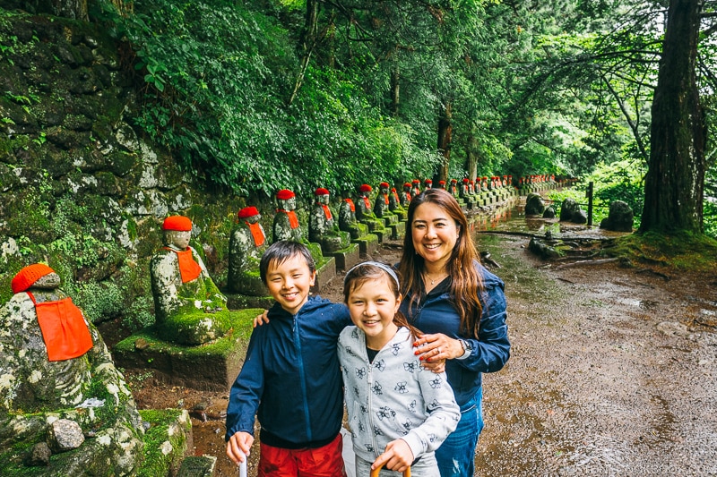 family in front of jizo statues at Kanmangafuchi Abyss 憾満ヶ淵- Places to Visit and Things to do in Nikko | www.justonecookbook.com