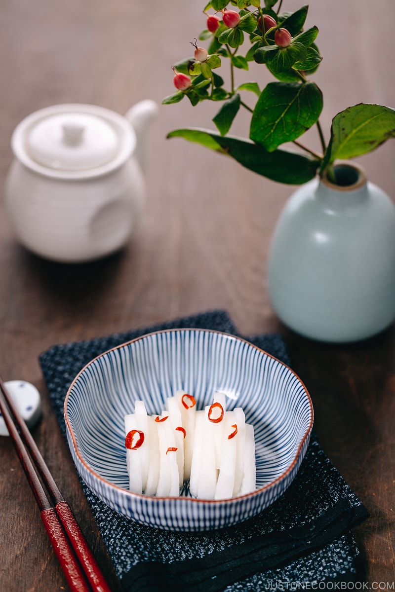 Japanese Pickled Daikon in a Japanese blue ceramic bowl.