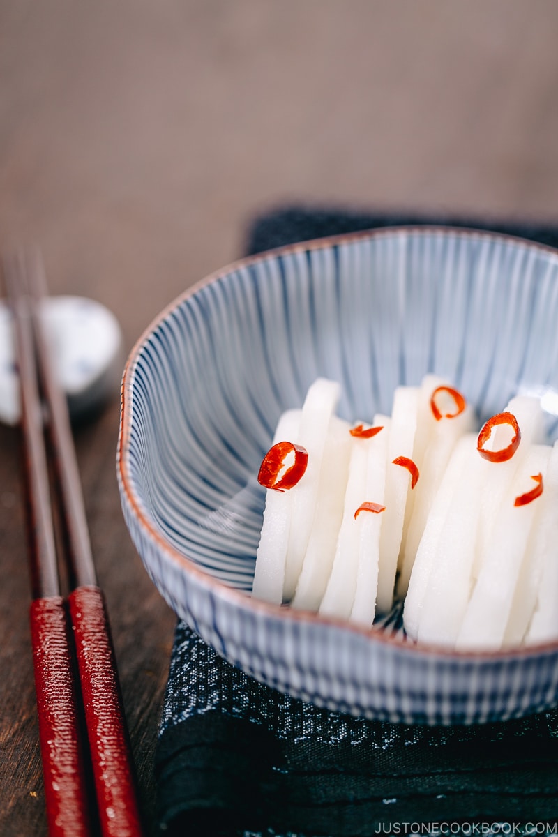 Japanese Pickled Daikon in a Japanese blue ceramic bowl.