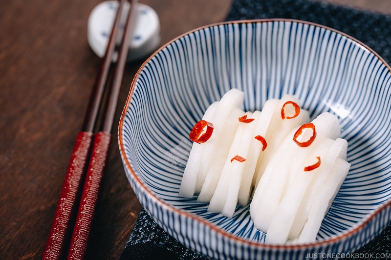 Japanese Pickled Daikon in a Japanese blue ceramic bowl.