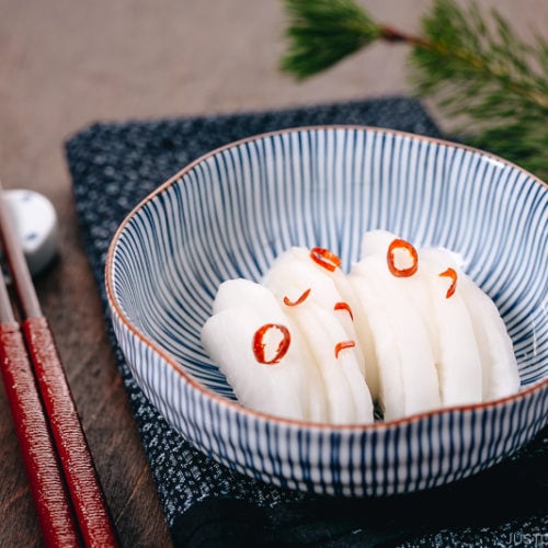 Japanese Pickled Daikon in a Japanese blue ceramic bowl.