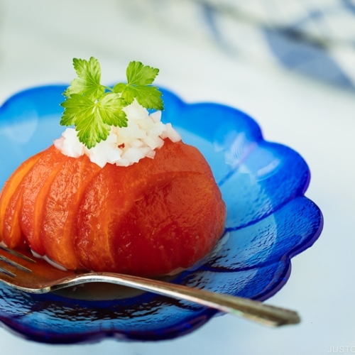 Pickled Tomatoes on a blue plate.