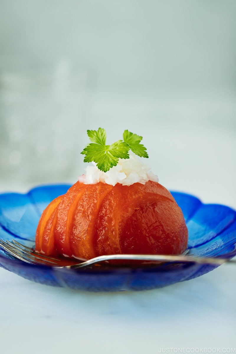 Pickled Tomatoes on a blue plate.