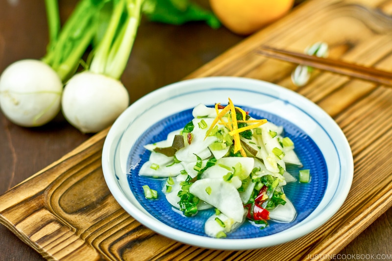 Pickled Turnip with Yuzu on a blue plate.