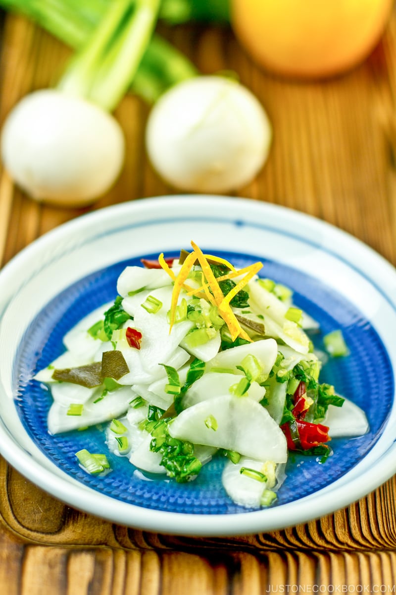 Pickled Turnip with Yuzu on a blue plate.