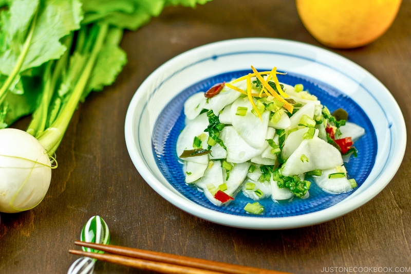 Pickled Turnip with Yuzu on a blue plate.