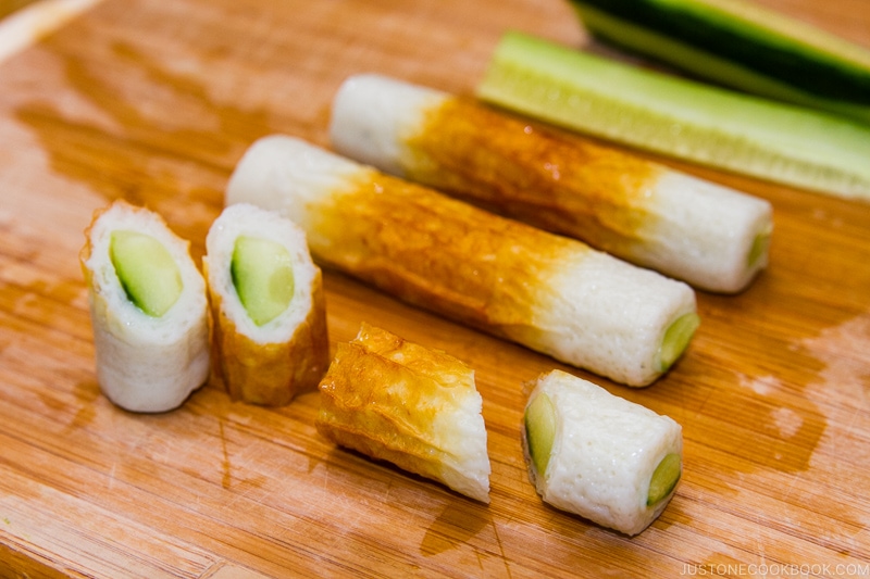 cucumber stuff inside chikuwa on wood cutting board