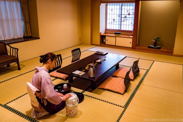 A hostess preparing tea in ryokan room